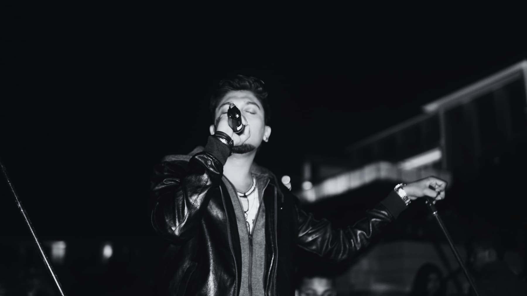 Harsh Shetty singing during a live performance